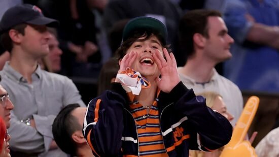 Timothée Chalamet high-fives fellow Knicks fans after Game 6 victory vs. Celtics