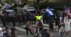 Reporter falls back with dispersed L.A. protesters amid flash-bangs, tear gas