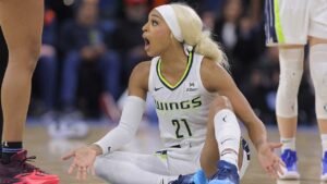 DiJonai Carrington pushes back after referees call security during Wings game