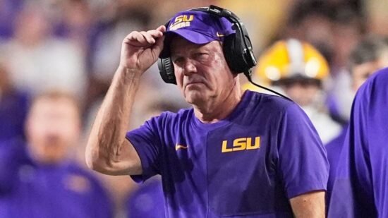 LSU’s Brian Kelly gets hit during play