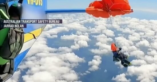 Skydiver dangles from plane after parachute gets tangled
