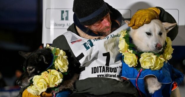 Former reality TV star Jessie Holmes wins Iditarod sled dog race again, rewards canine team with large steaks
