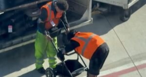 Bystanders cheer for baggage handlers after they finally fold baby stroller
