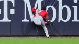 Reds outfielder Dane Myers carted off after crashing into wall on catch