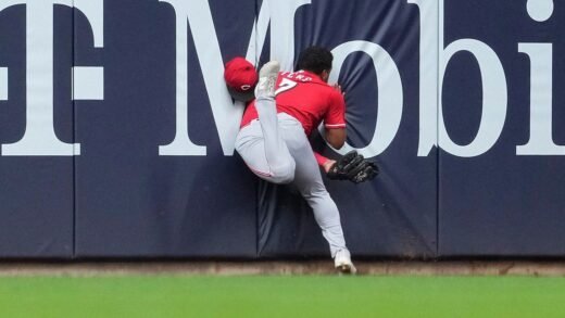 Reds outfielder Dane Myers carted off after crashing into wall on catch
