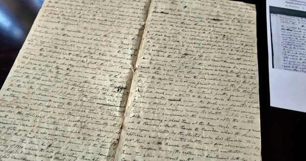 Volunteers deciphering first-person Revolutionary War accounts written in cursive