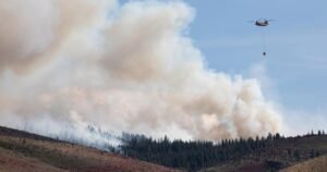 Firefighters battle flames and smoke near Reno fueled by drought and wind