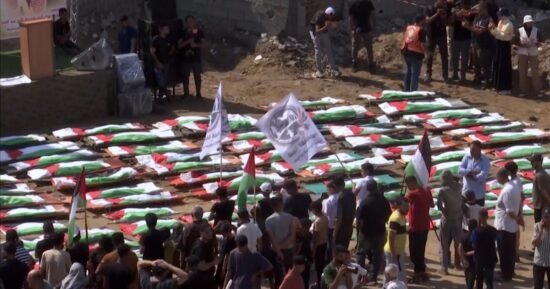 Mourners hold a mass funeral for 112 recovered bodies in Gaza