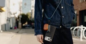 A word with a woman trying to pull off a crossbody phone strap