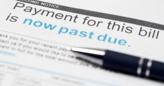 Squeezed by inflation, more Americans are falling behind on debt payments