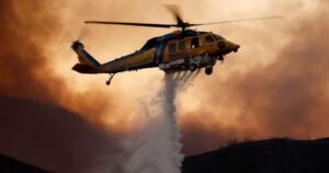 Thousands evacuate as massive California fires engulf homes